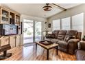 Inviting living room with hardwood floors, a comfortable couch, and natural light from the sliding glass door at 17200 W Bell Rd # 2221, Surprise, AZ 85374