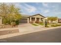 Charming home with a two-car garage, well-maintained landscaping, and a welcoming front porch at 20652 W Clearstream Dr, Buckeye, AZ 85396