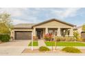 Charming home with a two-car garage, well-maintained landscaping, and a welcoming front porch at 20652 W Clearstream Dr, Buckeye, AZ 85396