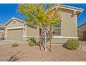 This lovely single-story home has a xeriscaped front yard and a neutral exterior paint scheme at 21090 E Camina Buena Vis, Queen Creek, AZ 85142