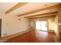 Open living space showcases hardwood floors, stone fireplace, and sliding glass doors at 219 W Denton Ln, Phoenix, AZ 85013