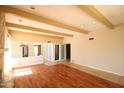 Spacious living room featuring a unique stone fireplace and hardwood flooring at 219 W Denton Ln, Phoenix, AZ 85013