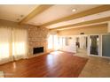 Bright living room boasts stone fireplace, hardwood floors, and ample natural light at 219 W Denton Ln, Phoenix, AZ 85013