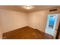 Spacious bedroom with neutral walls, closet, and doorway to the bathroom at 2502 W Jefferson St, Phoenix, AZ 85009