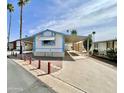 Charming exterior of home with covered parking, desert landscaping, and blue and white accents at 318 S Crismon Rd # 83, Mesa, AZ 85208