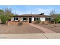 Charming single-story home featuring a brick pathway and a well-maintained front yard at 3221 N 41St Pl, Phoenix, AZ 85018