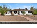 Inviting one-story home featuring a well-maintained yard and a charming brick-lined walkway at 3221 N 41St Pl, Phoenix, AZ 85018