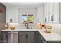 This modern kitchen features white herringbone backsplash, gray cabinets, and stainless steel appliances at 3221 N 41St Pl, Phoenix, AZ 85018