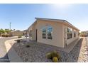 Attractive home with low-maintenance landscaping, complemented by gravel, cacti, and desert plants at 3301 S Goldfield Rd # 2034, Apache Junction, AZ 85119