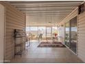 A covered patio with tile flooring, ample seating, and views of the surrounding community at 3301 S Goldfield Rd # 2034, Apache Junction, AZ 85119