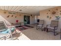 A covered patio with tile flooring, ample seating, and outdoor access at 3301 S Goldfield Rd # 2034, Apache Junction, AZ 85119