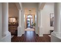 Foyer with columns, dark hardwood floors, neutral walls and decorative mirror in new home at 3634 E Sands Dr, Phoenix, AZ 85050