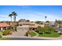 Charming two-story home featuring a three-car garage and a well-manicured lawn with mature trees at 4066 E Grandview St, Mesa, AZ 85205