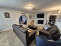 Inviting living room with an archway to another room, a gray brick fireplace, neutral paint, and modern furniture at 4231 E Roeser Rd, Phoenix, AZ 85040
