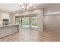 Open floorplan showcases a kitchen island with granite countertops and sliding glass doors to the patio at 4444 E Bethena St, Gilbert, AZ 85295
