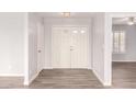 Inviting foyer with a double-door entry, light gray walls, and wood-look tile flooring at 4701 E Walatowa St, Phoenix, AZ 85044