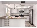 Well-lit kitchen featuring white cabinetry, stainless steel appliances, granite countertops, and a functional layout at 4701 E Walatowa St, Phoenix, AZ 85044