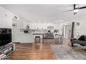 Bright living room featuring wood flooring, white walls, modern furnishings and stainless steel appliances at 5525 E Thomas Rd # K6, Phoenix, AZ 85018