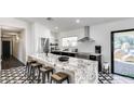 Modern kitchen featuring granite countertops, stainless steel appliances, and a stylish island with seating for four at 6527 W Bloomfield Rd, Glendale, AZ 85304
