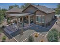 Enjoy outdoor living with this home's covered patio and low-maintenance backyard at 6756 W Patriot Way, Florence, AZ 85132