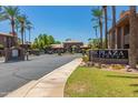 Welcoming entrance to The Plaza Residences with lush landscaping and mature palm trees at 7009 E Acoma Dr # 2134, Scottsdale, AZ 85254