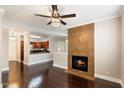 Bright living room with fireplace and hardwood floors; stylish ceiling fan and light fixture add charm at 7009 E Acoma Dr # 2134, Scottsdale, AZ 85254