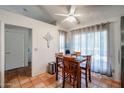 Dining area with Saltillo tile flooring, slider to patio, and ceiling fan at 7138 W Sierra Vista W Dr, Glendale, AZ 85303