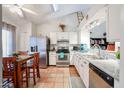 Bright kitchen featuring white cabinets, stainless steel appliances, and Saltillo tile flooring at 7138 W Sierra Vista W Dr, Glendale, AZ 85303