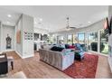 Bright, open living room with a view of the golf course, modern lighting, and wood-style flooring at 7400 E Gainey Club Dr # 123, Scottsdale, AZ 85258