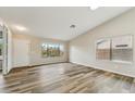 Bright living room with wood floors, large windows and natural light at 9306 E Fairbrook St, Mesa, AZ 85207