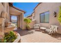 Inviting courtyard with seating area, water feature, wrought iron gate, and lush landscaping at 9834 E Voltaire Dr, Scottsdale, AZ 85260