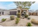 Lovely home with a spacious driveway, desert landscaping, and a welcoming entrance at 1189 E Tyler Ln, Casa Grande, AZ 85122