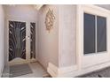 Close up on the front door, featuring security door with decorative sunburst and side window at 1559 E Peregrine Trl, Casa Grande, AZ 85122
