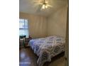 Comfortable bedroom with laminate floors, a window, and a ceiling fan at 17821 N Woodrose Ave, Surprise, AZ 85374