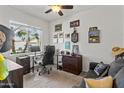 A functional bedroom that is currently staged as a home office with a window providing plenty of natural light at 22419 W La Pasada Blvd, Buckeye, AZ 85326