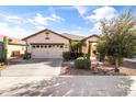 Beautiful single-story home with desert landscaping, a two-car garage, and a well-maintained front yard at 22419 W La Pasada Blvd, Buckeye, AZ 85326