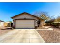 A single-Gathering home featuring a two-car garage and manicured landscaping at 22727 W Papago St, Buckeye, AZ 85326