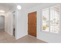 Bright foyer featuring tile floors, wood door and window with shutter, and ample natural light at 24832 S Boxwood Dr, Sun Lakes, AZ 85248