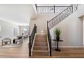 Elegant foyer featuring a staircase with rod iron detail and wood flooring at 2517 W Balao Dr, Phoenix, AZ 85085