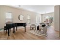 Open-concept living room showcasing ample natural light, a piano, and modern decor at 2517 W Balao Dr, Phoenix, AZ 85085