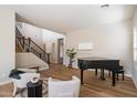 Spacious living room boasting wood flooring, staircase, and comfortable seating at 2517 W Balao Dr, Phoenix, AZ 85085