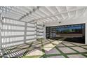 Modern patio with pergola cover, beautiful brick and artificial turf design, and glass garage door entrance at 2629 S Country Club Way, Tempe, AZ 85282