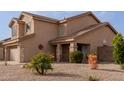 Home exterior with xeriscape landscaping, highlighted by a covered front porch and stone pillars at 3234 E Marco Polo Rd, Phoenix, AZ 85050