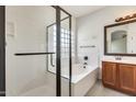 Bathroom featuring a soaking tub with a glass shower enclosure and a vanity with modern fixtures at 328 W Dragon Tree Ave, San Tan Valley, AZ 85140