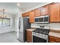 Kitchen with stainless steel appliances and adjacent dining area at 328 W Dragon Tree Ave, San Tan Valley, AZ 85140