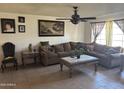 Comfortable living room featuring a large sectional sofa and decorative artwork on the walls at 3307 W Ocotillo Rd, Phoenix, AZ 85017