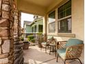 Inviting front porch with stone columns and comfortable seating, perfect for relaxing at 3522 E Spring Wheat Ln, Gilbert, AZ 85296