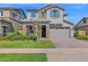 Charming two-story home with a manicured lawn, stone accents, and a two-car garage at 3830 E Appaloosa Rd, Gilbert, AZ 85296