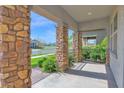 Covered front porch featuring stone columns and decorative iron railings at 3830 E Appaloosa Rd, Gilbert, AZ 85296