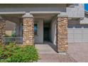 Inviting front porch with stone columns and a view of lush landscaping at 3830 E Appaloosa Rd, Gilbert, AZ 85296